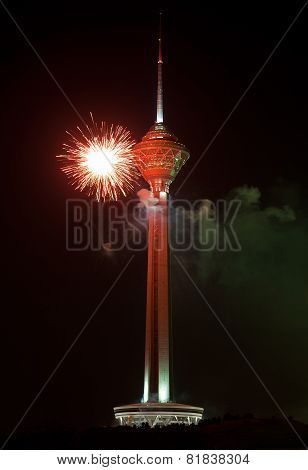 Milad Tower Illuminated With Red Firework Against Black Sky