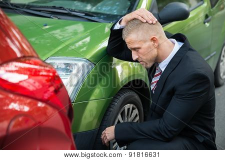 Upset Driver Looking At Car After Traffic Collision