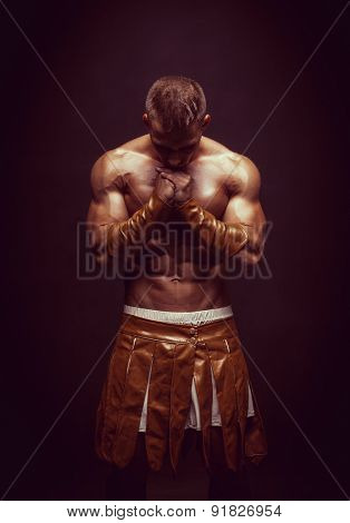 Rome warrior praying on the black background