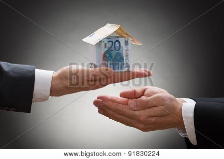 Businessman Giving House To The Businessperson