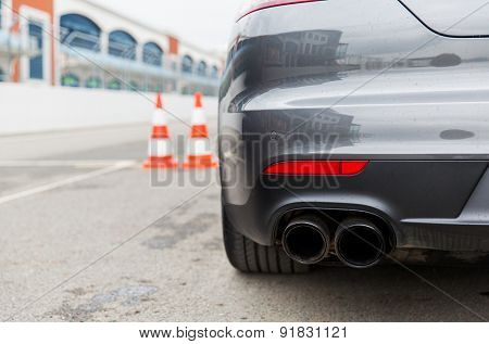 racing, motosports, extreme and motoring concept - close up of sports car back on speedway of stadium