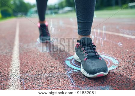 fitness, sport, training, people and healthy lifestyle concept - close up of woman feet running on track with futuristic holograms