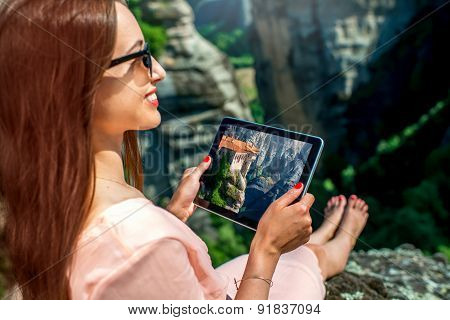 Woman photographing Meteora monastery in Greece