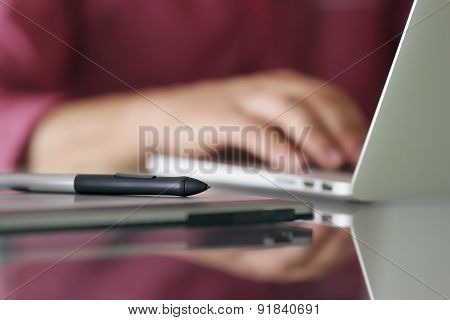 Designer Using Grafic Tablet And Laptop Writes On Keyboard