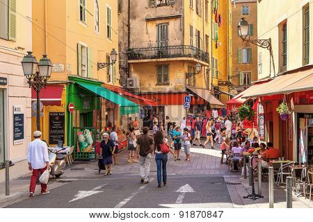 NICE, FRANCE - AUGUST 23, 2014: Tourists in Old City of Nice - fifth most populous and second-largest French city on Mediterranean coast and one of most visited with 4 million tourists every year.