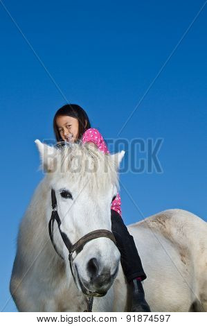 Girl Ridding A White Horse In Denmark