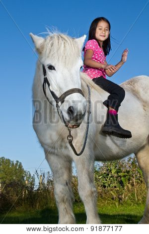 Girl Ridding A White Horse In Denmark