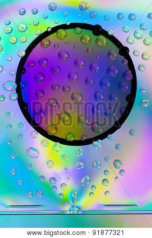 Amazing colors of white light that pass through the clear plastic, water drops and CPL filter.