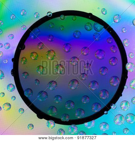 Amazing colors of white light that pass through the clear plastic, water drops and CPL filter.