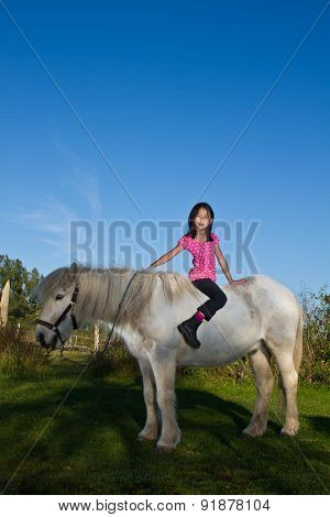 Girl Ridding A White Horse In Denmark
