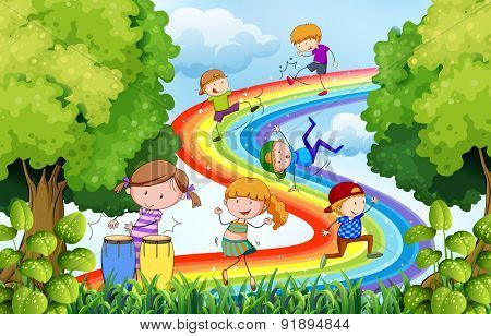 Children playing over the colorful rainbow