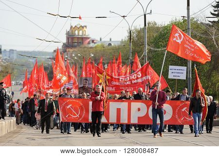 Orel Russia - May 1 2016: Communist party demonstration. Crowd of people with red Soviet flags horizontal