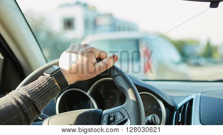 Closeup Of A Man Hands Holding Steering Wheel While Driving Car with retro filter effect