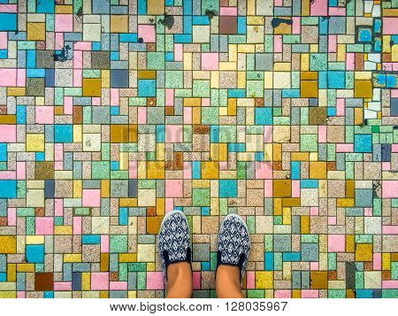 Colorful pavers and feet, brick road and feet