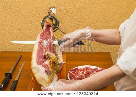 person cutting jamon, jamon cutter, person working