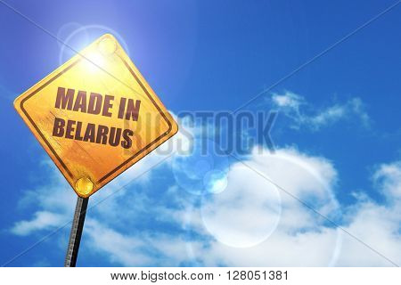Yellow road sign with a blue sky and white clouds: Made in belar