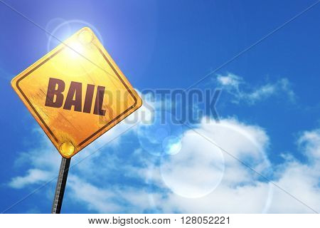 Yellow road sign with a blue sky and white clouds: bail