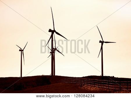Sihouette of wind turbines in the hills of Southwest Oklahoma .