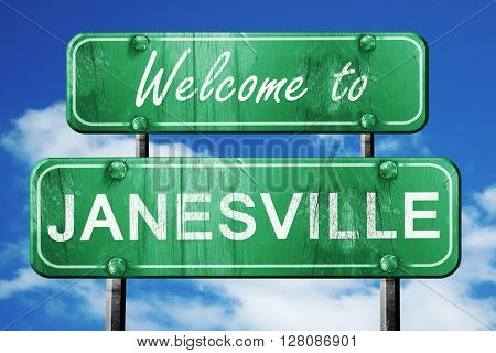 janesville vintage green road sign with blue sky background