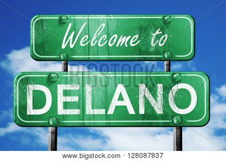 delano vintage green road sign with blue sky background