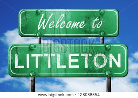 littleton vintage green road sign with blue sky background