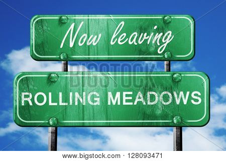 Leaving rolling meadows, green vintage road sign with rough lett