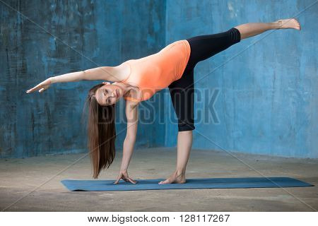 Sporty Beautiful Young Woman Doing Half Moon Pose