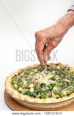Quiche lorraine preparation : Adding parmesan cheese to the spinach and tuna quiche lorraine
