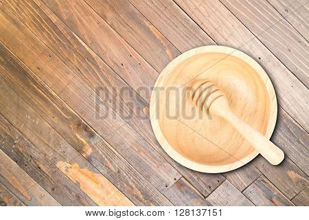 Wooden bowl and dipper on wood texture background, stock photo
