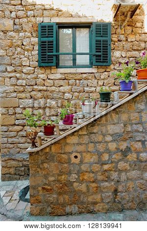 Ulcinj Stari Grad alley with venetian blinds and colorful pots flowered , Montenegro
