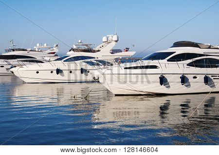 White yachts in the port. On the sea is calm.