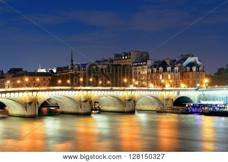 River Seine and Pont Neuf at night in Paris, France.