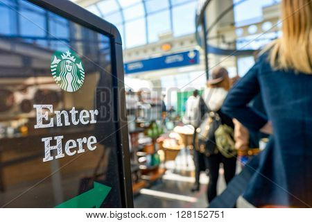 CHICAGO, IL - CIRCA APRIL, 2016: Starbucks Cafe at O'Hare Airport. Starbucks Corporation is an American global coffee company and coffeehouse chain based in Seattle, Washington