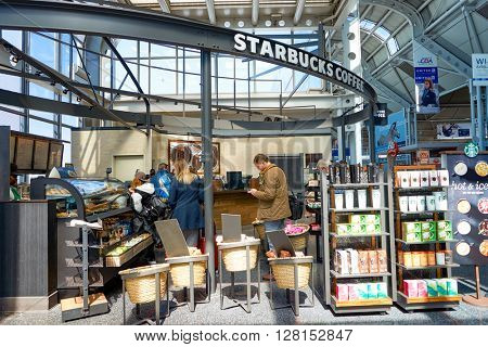 CHICAGO, IL - CIRCA APRIL, 2016: Starbucks Cafe at O'Hare Airport. Starbucks Corporation is an American global coffee company and coffeehouse chain based in Seattle, Washington