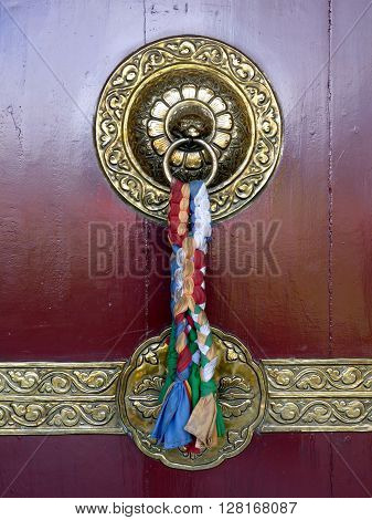Beautifully Ornate Traditional Brass Door Knocker With Coloured Ribbons On Buddhist Temple In Pokhar