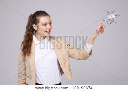Woman scientist with atom model, research concept