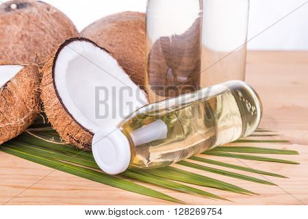 Cold Pressed Extra Virgin Coconut Oil In Bottles With Coconuts