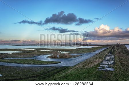 Evening sunset clouds in the quaint traditional Dutch landscape.