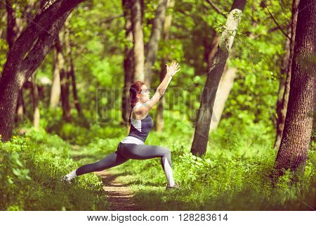 Young girl doing yoga in the park