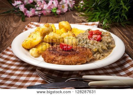 Delicious Meal Of Minced Meat Cutlet, Potatoes And Fried Cabbage.