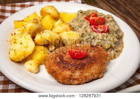 Delicious Meal Of Minced Meat Cutlet, Potatoes And Fried Cabbage.