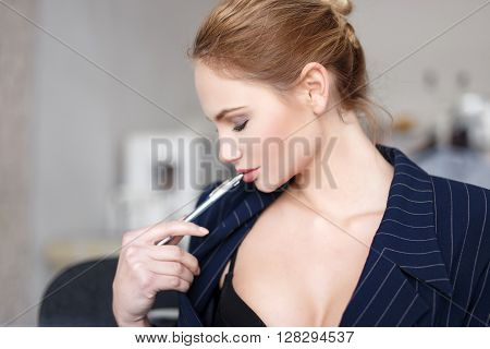 Sexy secretary dreaming during worktime about men