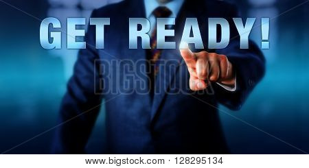 Corporate coach is touching GET READY! on a virtual interactive display. Motivational appeal call to action and business concept for preparation in anticipation of future events.