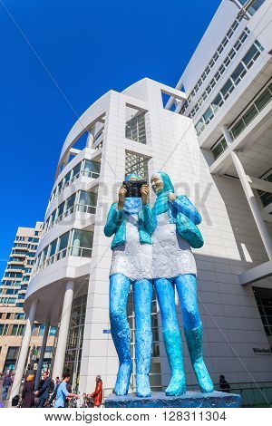 The Hague Netherlands - April 21 2016: sculpture in front of the New City Hall of The Hague with unidentified people. It was designed in 1986 by American architect Richard Meier and completed 1995