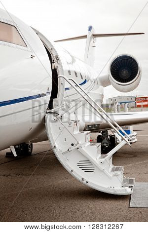 Ladder with open door in business jet airplane