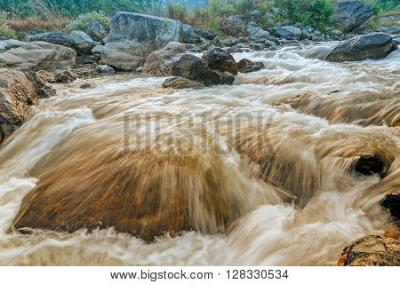 Beautiful Reshi River water flowing through stones and rocks at dawn Sikkim India. Reshi is one of the most famous rivers of Sikkim flowing through the state and serving water to many local people.