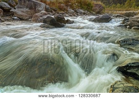 Beautiful Reshi River water flowing through stones and rocks at dawn Sikkim India. Reshi is one of the most famous rivers of Sikkim flowing through the state and serving water to many local people.