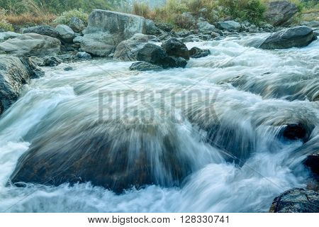Beautiful Reshi River water flowing through stones and rocks at dawn Sikkim India. Reshi is one of the most famous rivers of Sikkim flowing through the state and serving water to many local people.