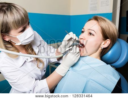 The reception was at the female dentist. Doctor examines the oral cavity on tooth decay. Caries protection. doctor puts the patient an anesthetic injection. close-up of the patient's mouth and squirt.
