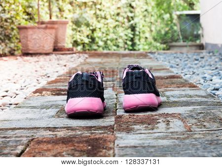 Running shoes in home garden foot path, stock photo
